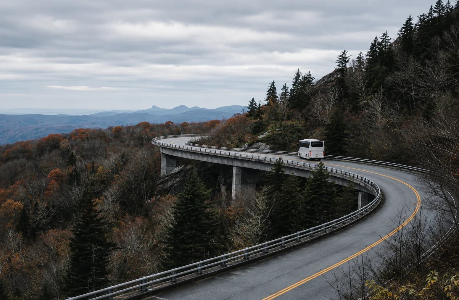 A charter bus crossing the Linn Cove Viaduct on North Carolina's Blue Ridge Parkway in autumn