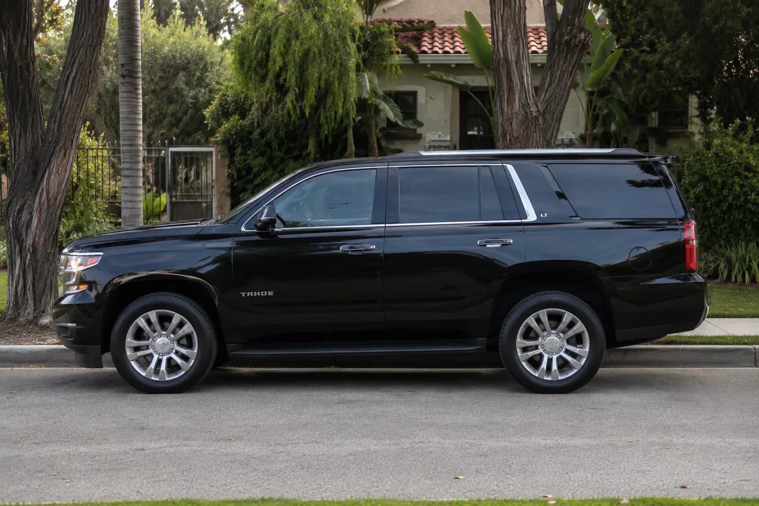 Black luxury SUV parked curbside